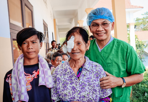 Slechtziende oma met kleinzoon en oogarts in een kliniek in Cambodja